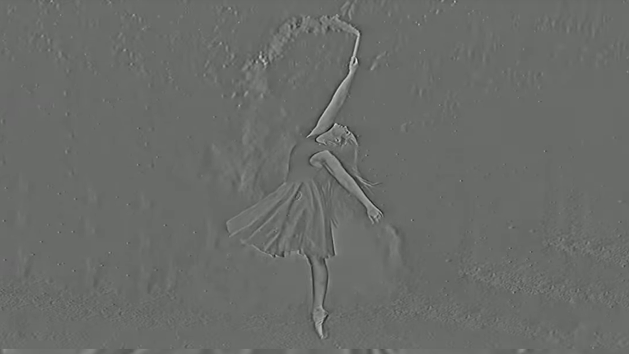 A still image from a video illusion. A dancer appears in strange gray-on-gray relief.